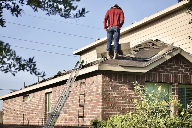 Professional roofer working on a residential roof in Virginia Gardens